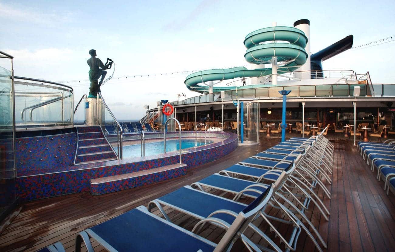 Carnival Miracle pool deck with waterslide loungers and open air seating