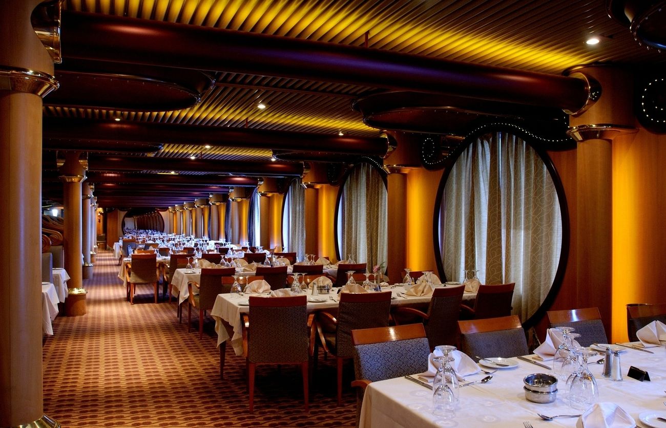 Elegant main dining room with tall columns and softly lit tables