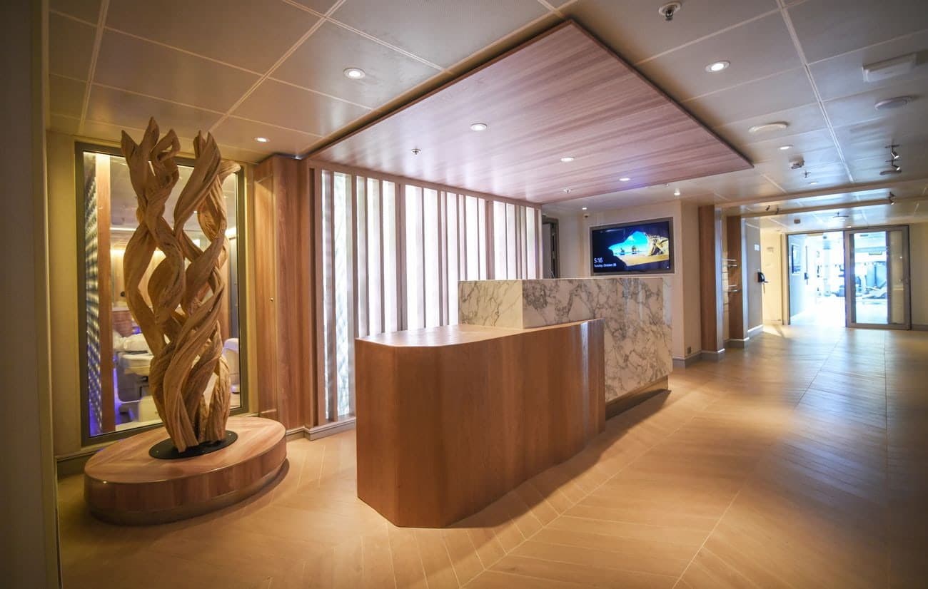 Spa reception area with wood finishes and marble desk