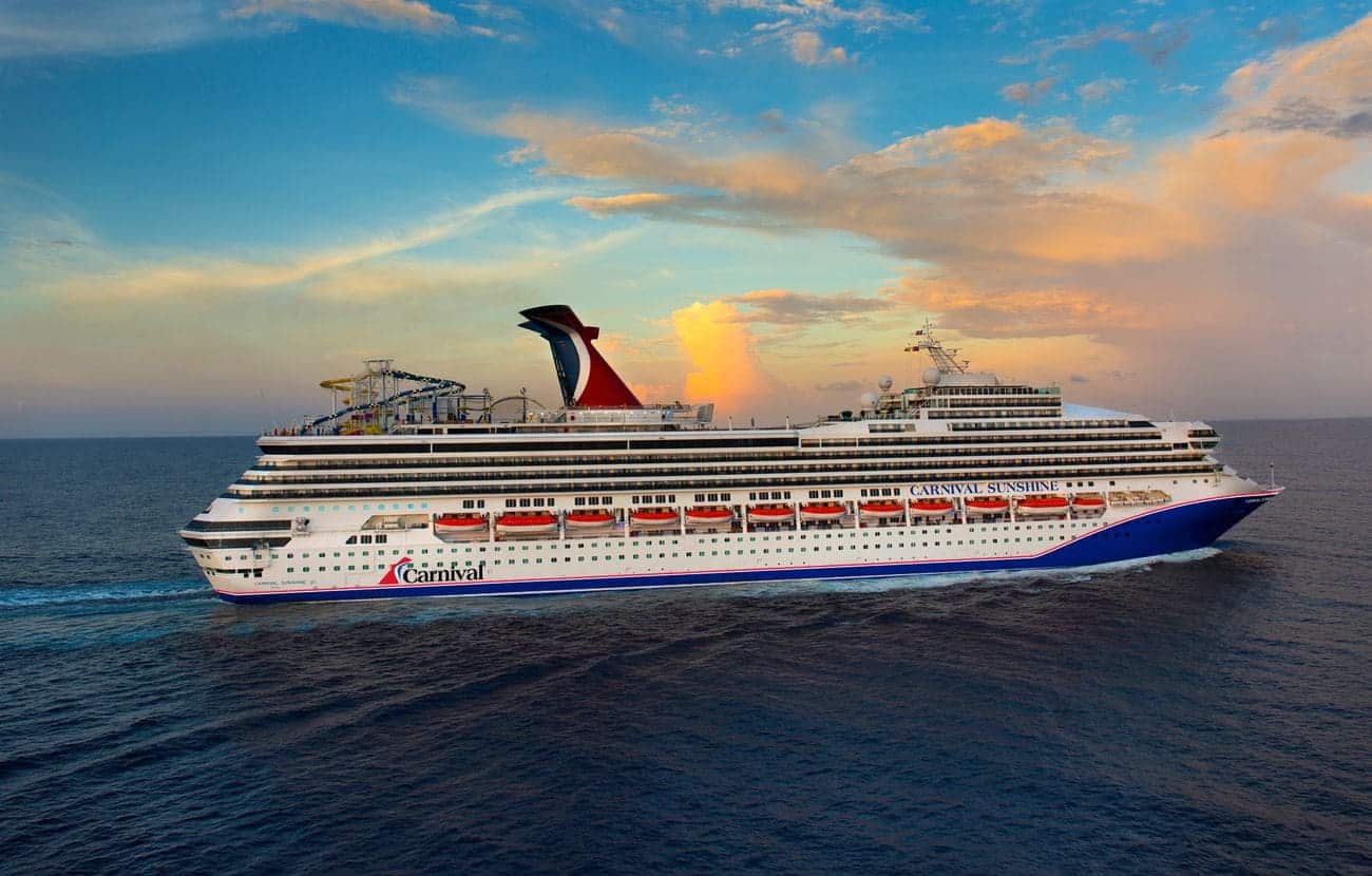 Carnival Sunshine in a full starboard-side exterior view at sea under a pastel evening sky