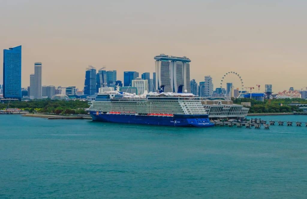 Cruise ship docked in Singapore with Marina Bay skyline behind