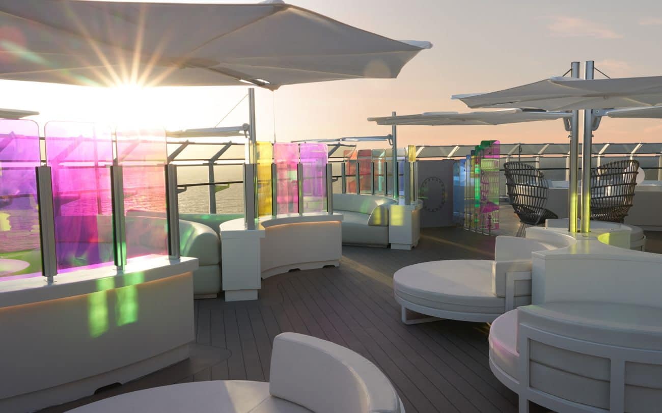 Richard’s Rooftop outdoor lounge on Resilient Lady with colorful glass panels at sunset
