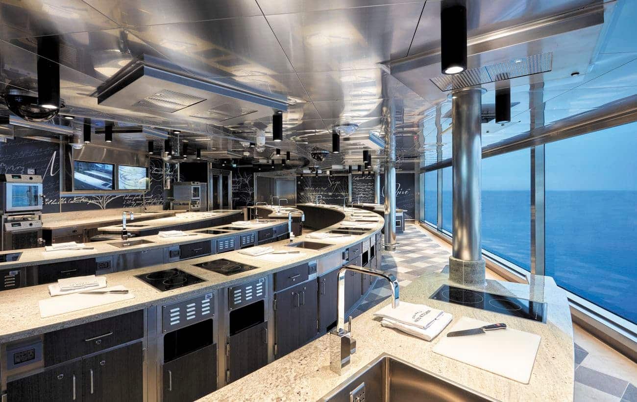 Culinary Arts Kitchen cooking studio with individual workstations and ocean-view windows on a luxury cruise ship