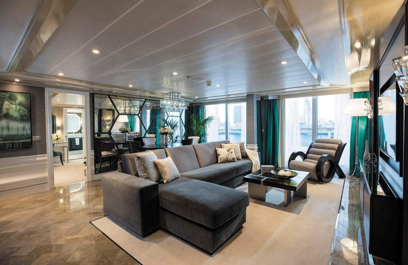 Seven Seas Explorer Grand Suite living room with marble floors, panoramic windows, and elegant contemporary furnishings
