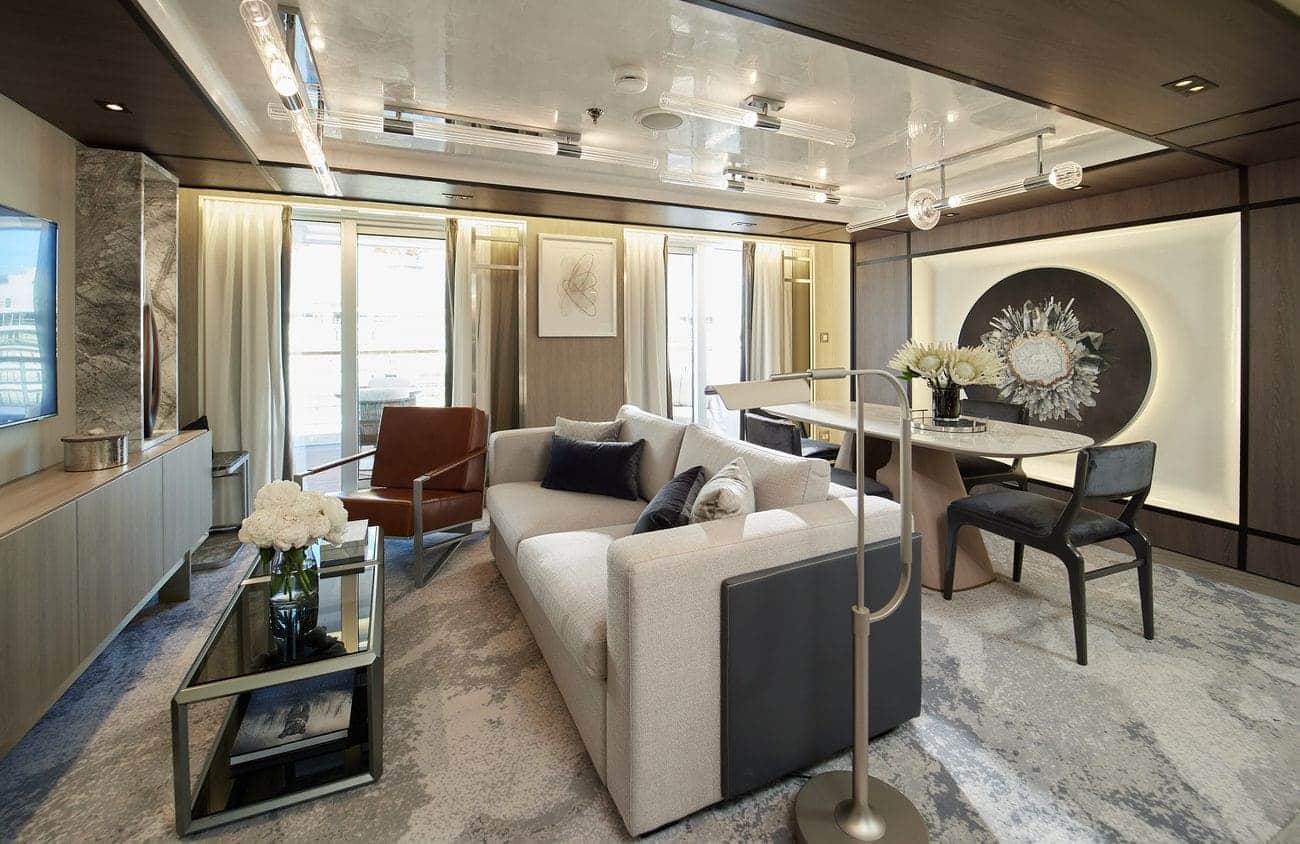 Spacious balcony suite living room with modern décor on Seven Seas Grandeur