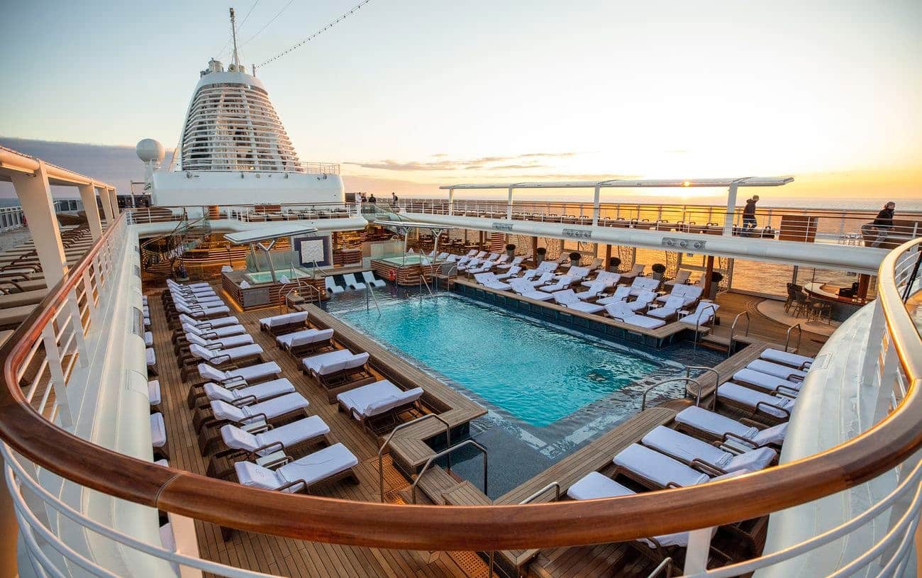 Pool deck with lounge chairs and ocean views