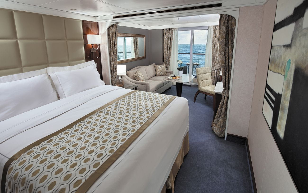 Deluxe Veranda Suite bedroom with private balcony on Seven Seas Voyager