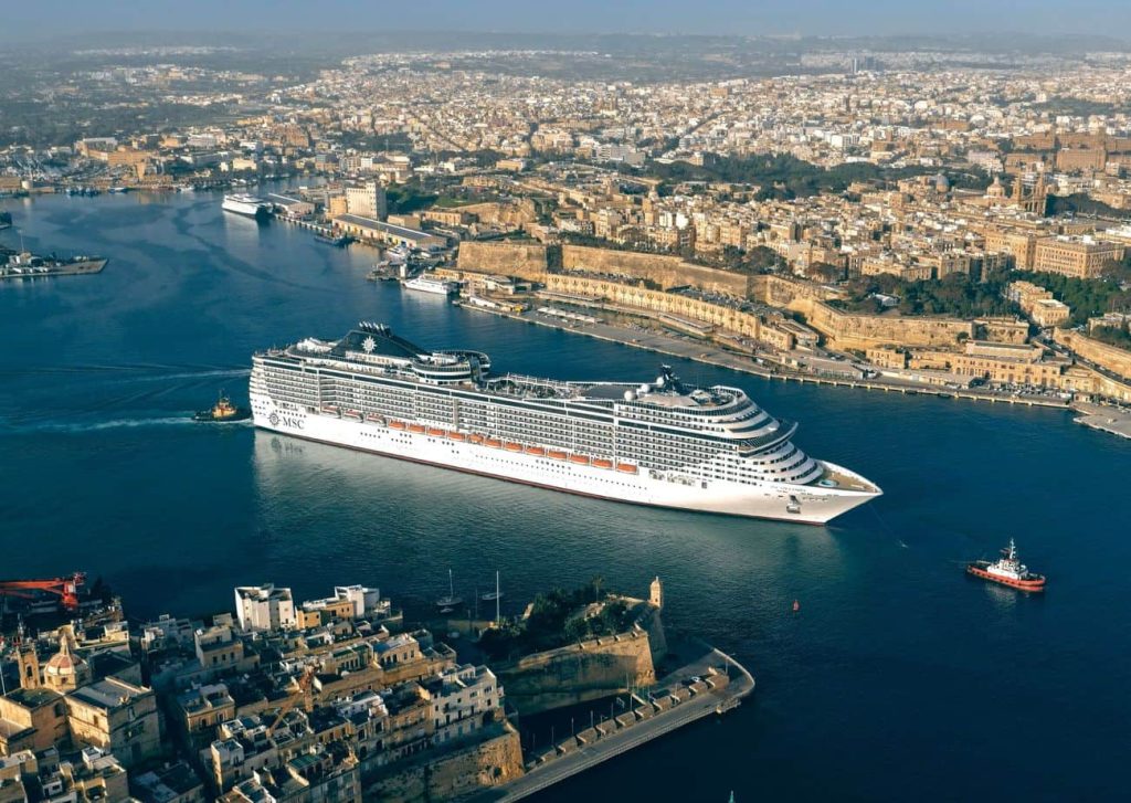 MSC Splendida sailing through Valletta harbor after refurbishment
