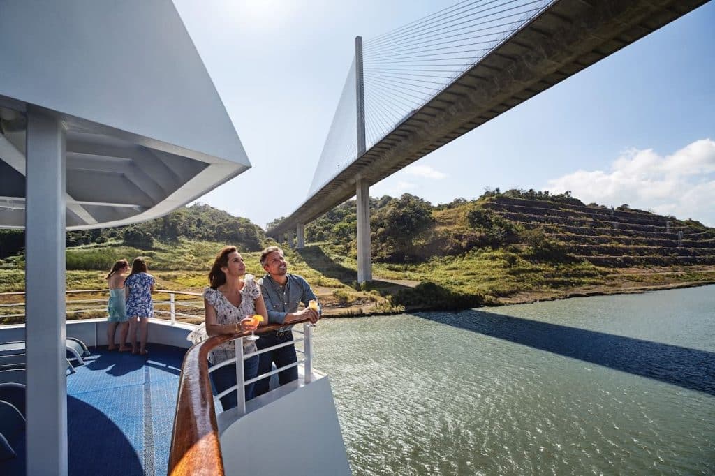 Guests on Island Princess watch Centennial Bridge spanning the Panama Canal from the outer deck