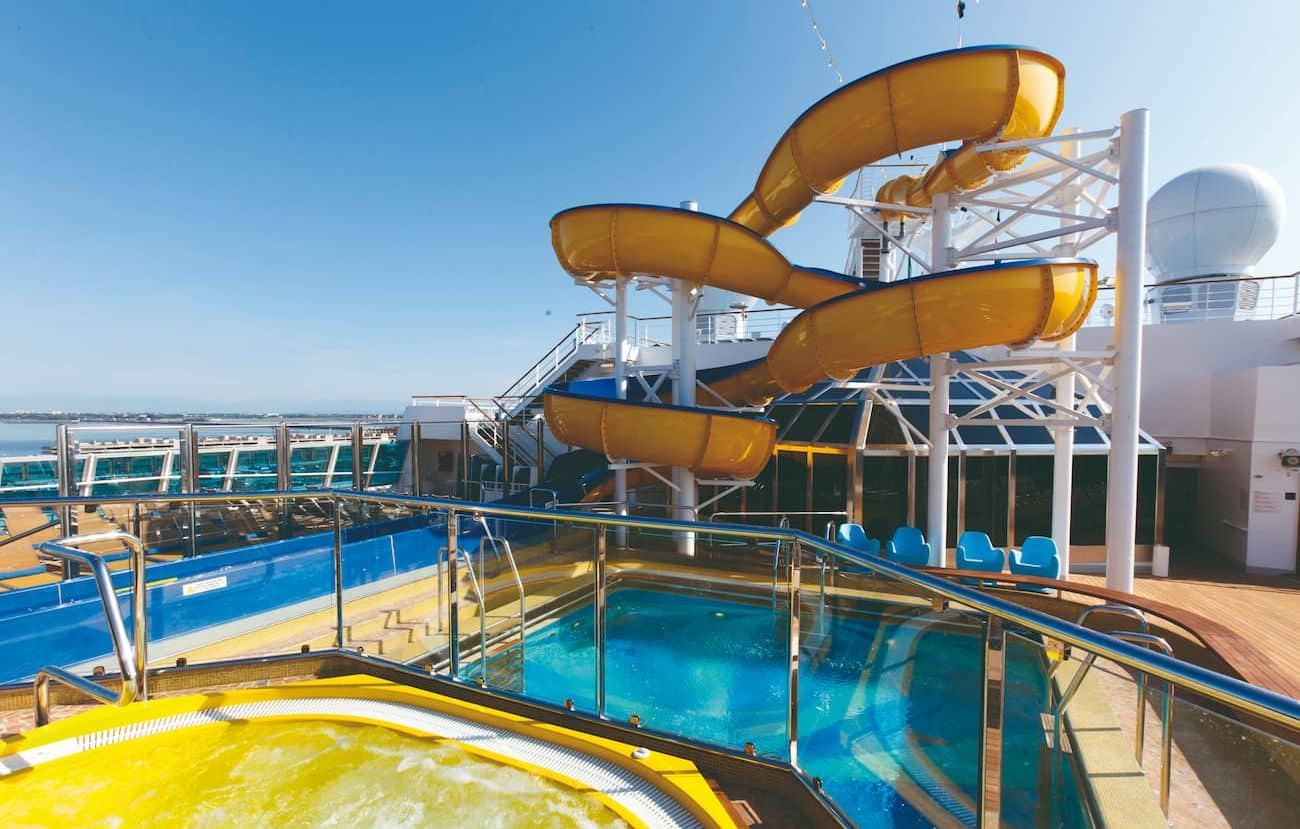 Yellow waterslide and pool area on the upper deck