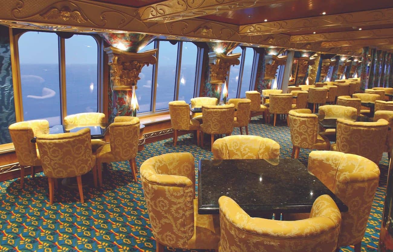 Grand Bar Conte di Savoia 1932 with golden armchairs, dark tables, and large oceanview windows.
