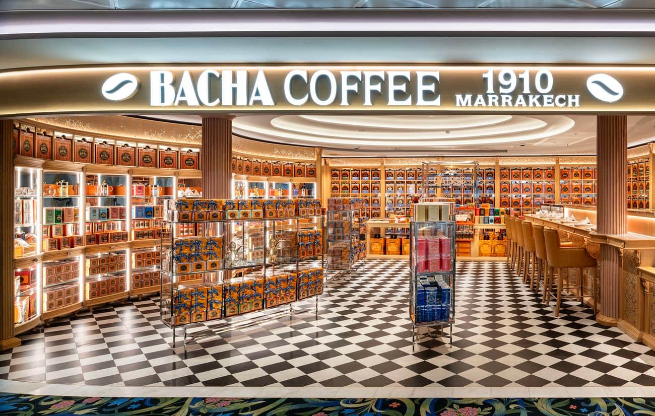 Bacha Coffee 1910 Marrakech boutique aboard Disney Adventure, with glowing displays, checkerboard flooring, and a tasting counter