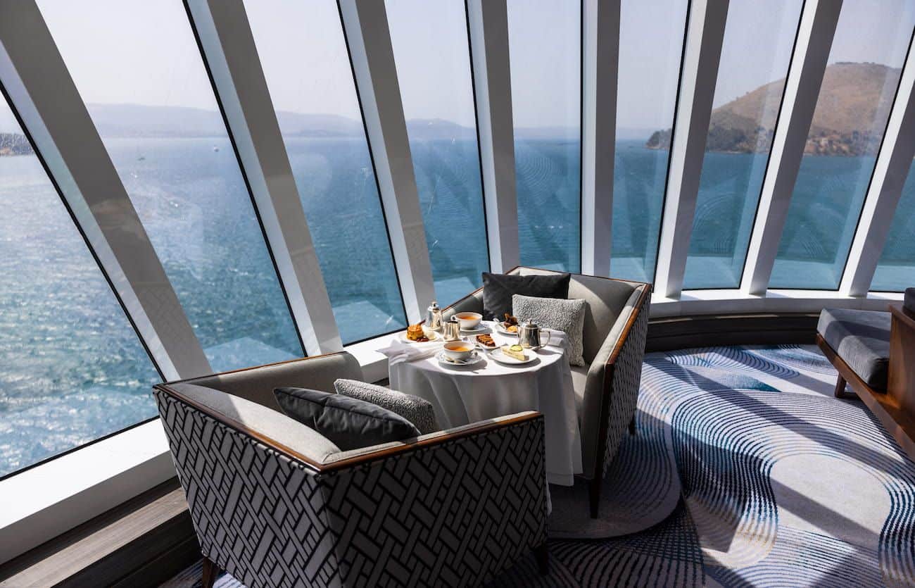 Horizons Observation Lounge seating beside floor-to-ceiling windows overlooking the sea