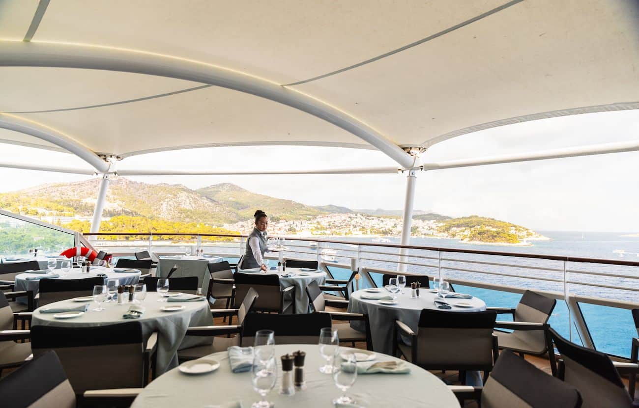 Oceania Allura Terrace Cafe outdoor dining area with sea and coastal views