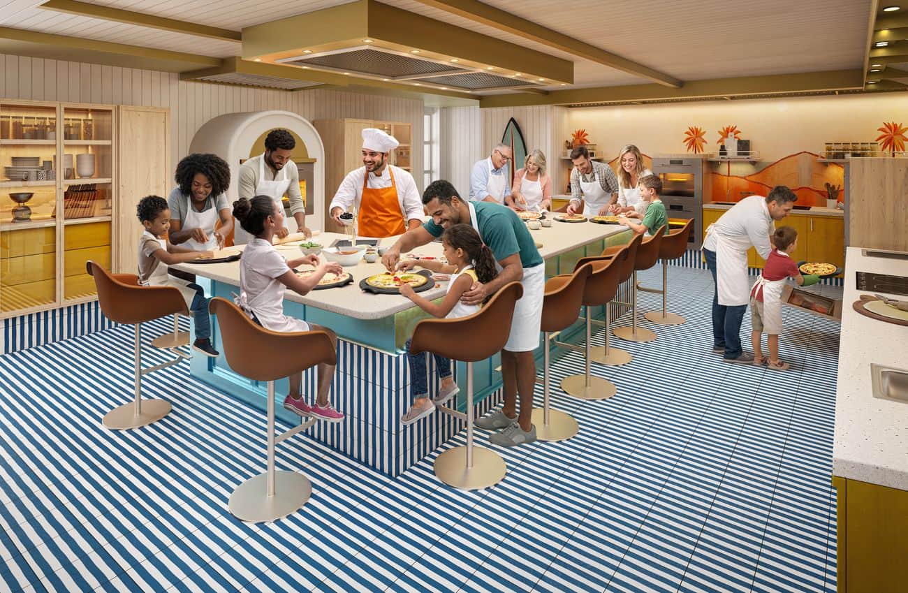 New Cooking Classes kitchen with families making pizzas around a central island, wall ovens, and striped flooring