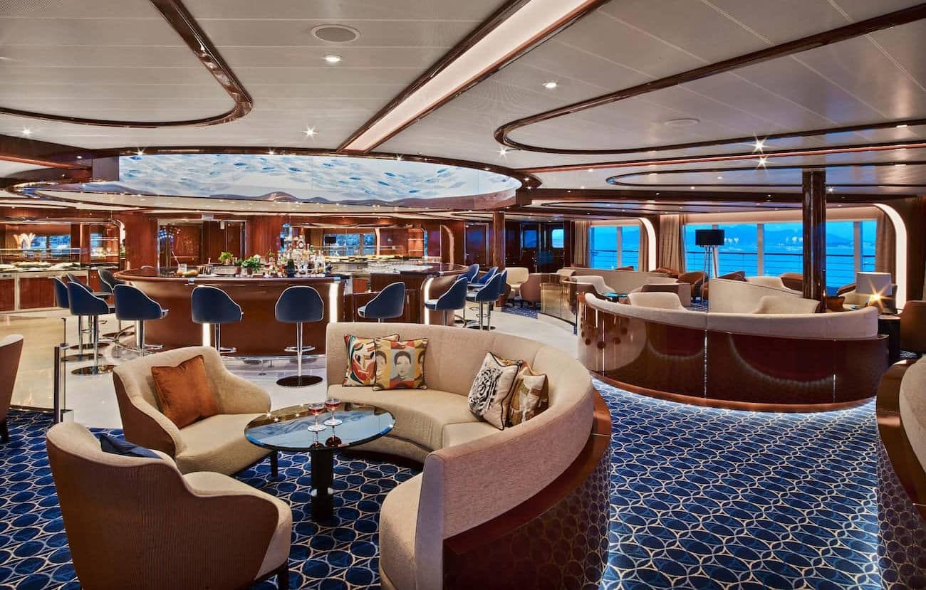 Seabourn Encore Observation Bar with central bar, curved seating, and ocean views.