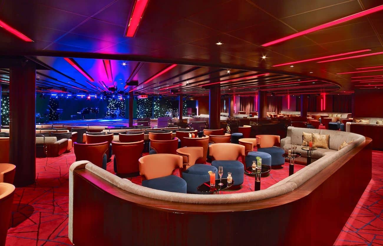 Grand Salon lounge with stage seating and colorful lighting