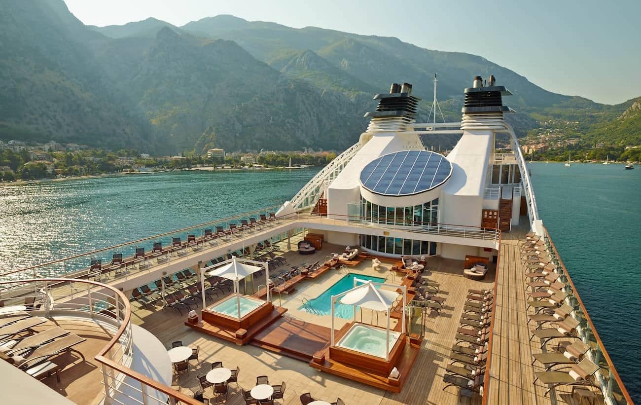 Pool Deck aboard Seabourn Quest overlooking Kotor, Montenegro with loungers, whirlpools, and mountain views