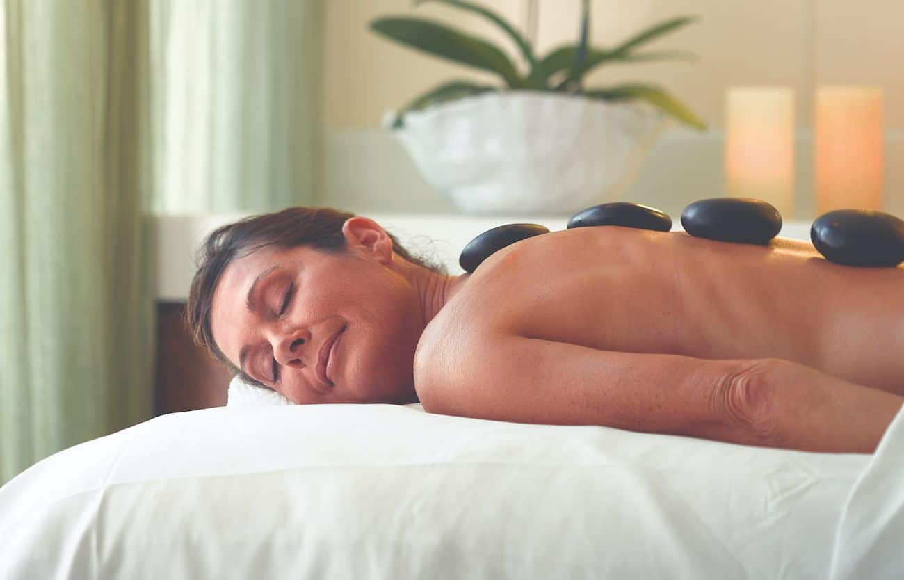 Oceania Marina Aquamar Spa treatment room with hot stone massage setup