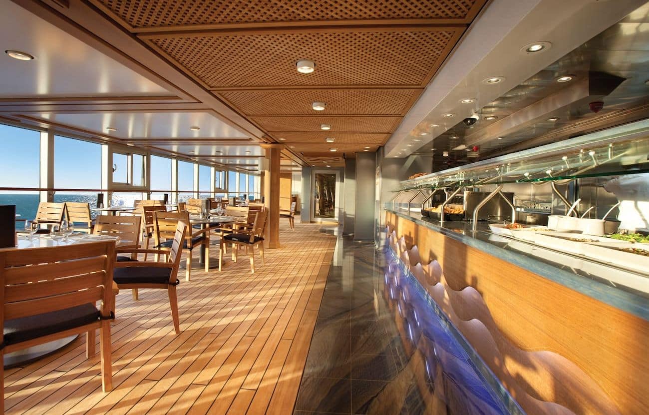 Waves Grill outdoor dining area with buffet counter and sea views