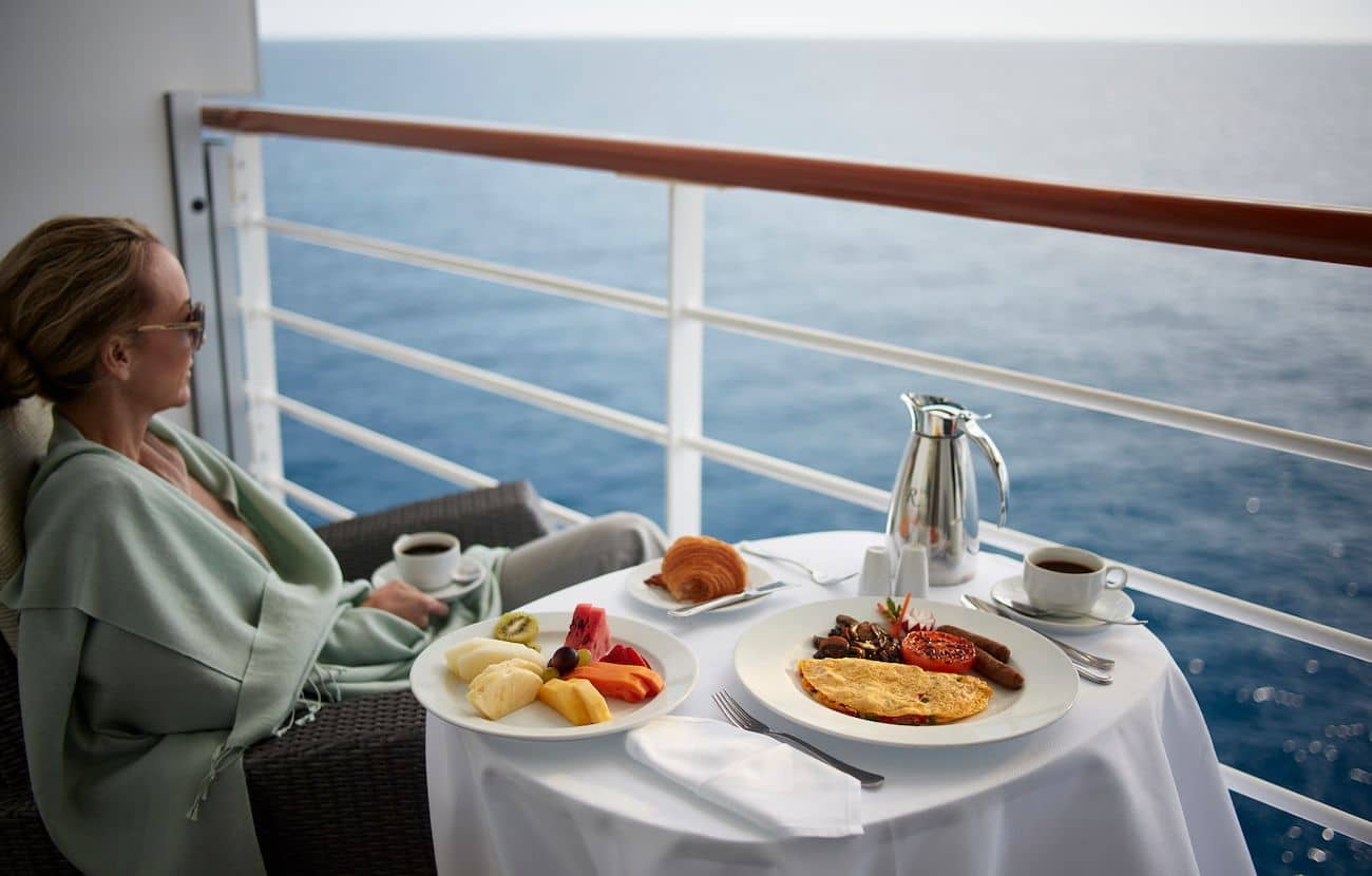 Stateroom balcony room service breakfast served beside open ocean views