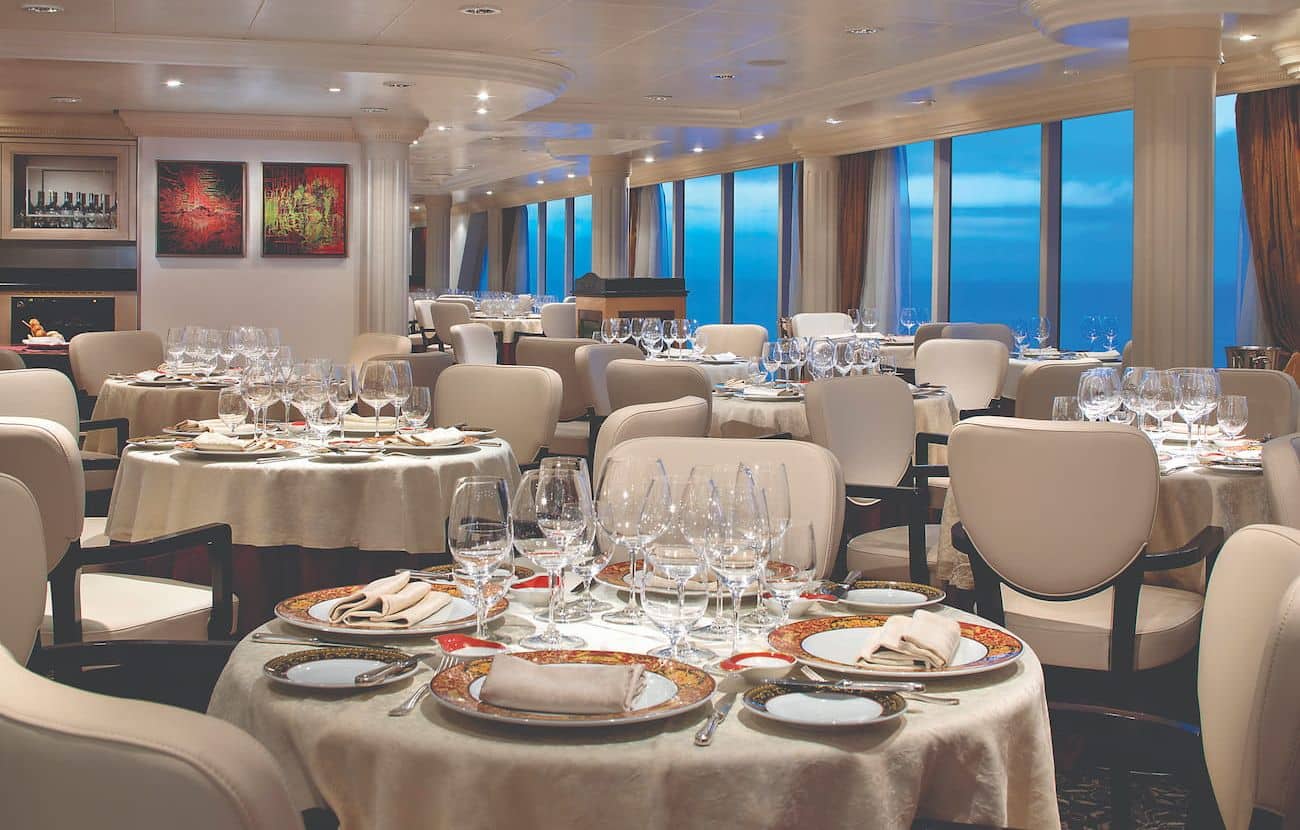 Oceania Nautica Toscana restaurant set for dinner with ocean-facing windows