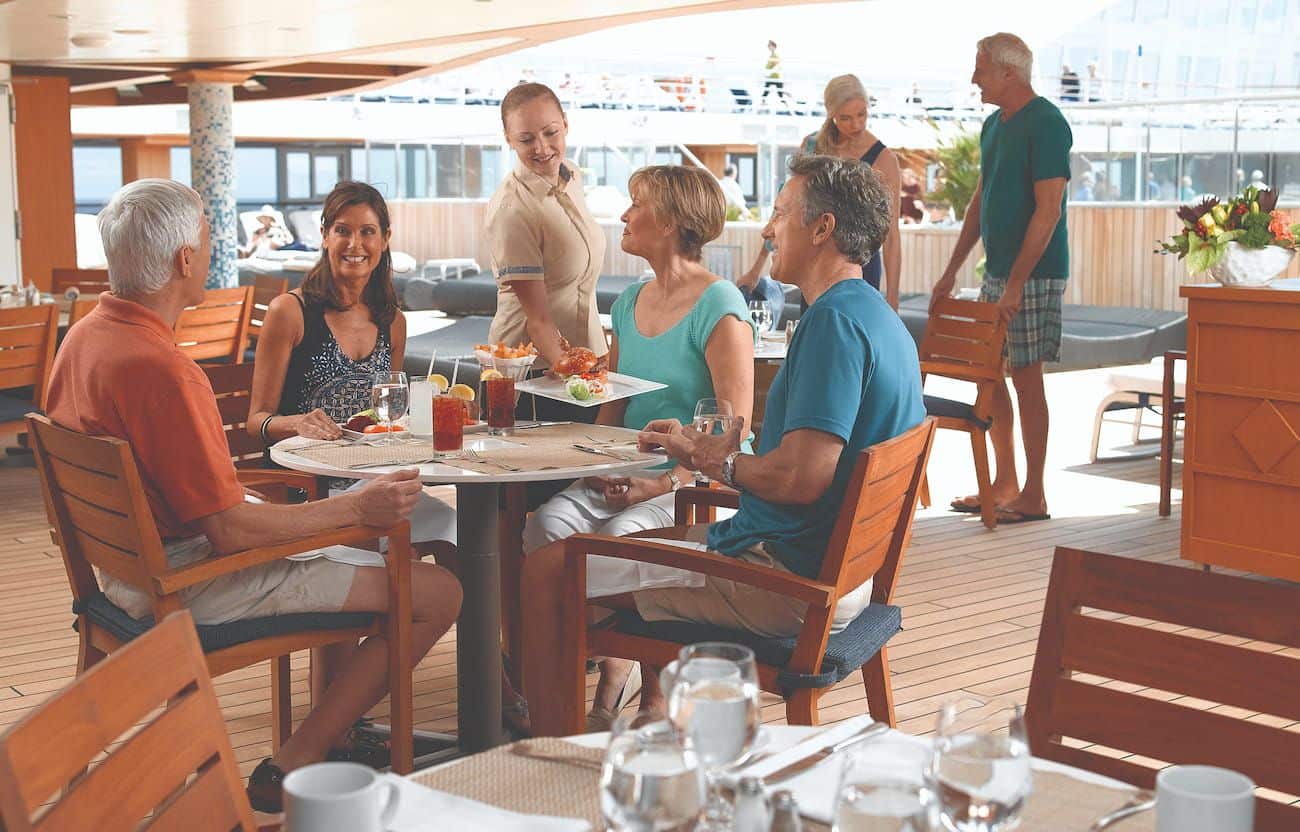 Guests dining outdoors at Waves Grill