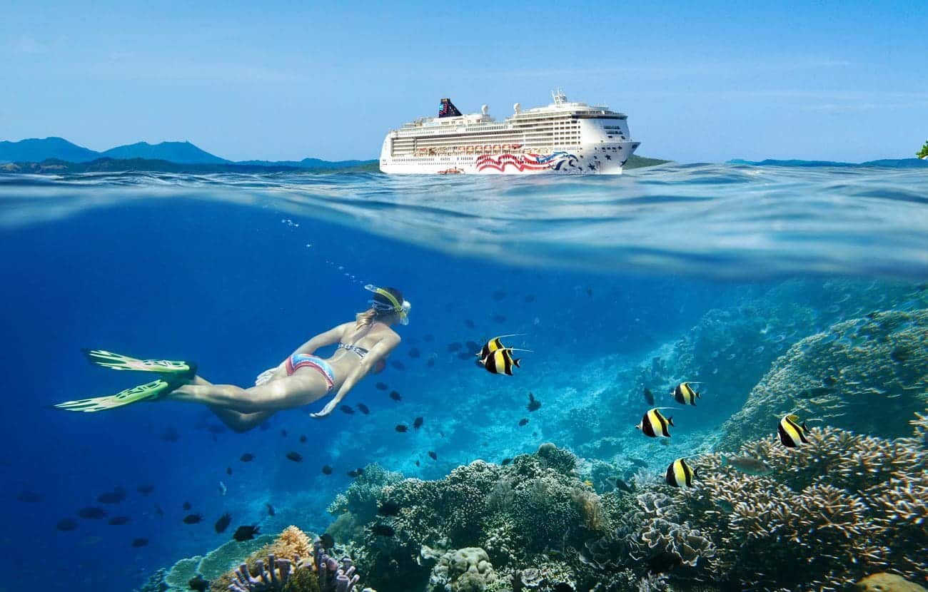 Pride of America near snorkeler and coral reef