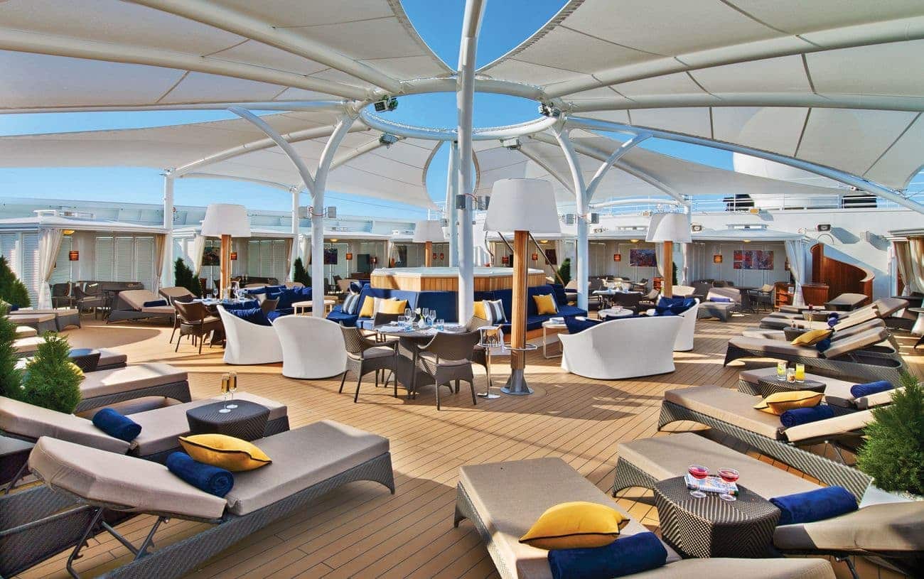 The Retreat aboard Seabourn Encore with shaded loungers and outdoor seating