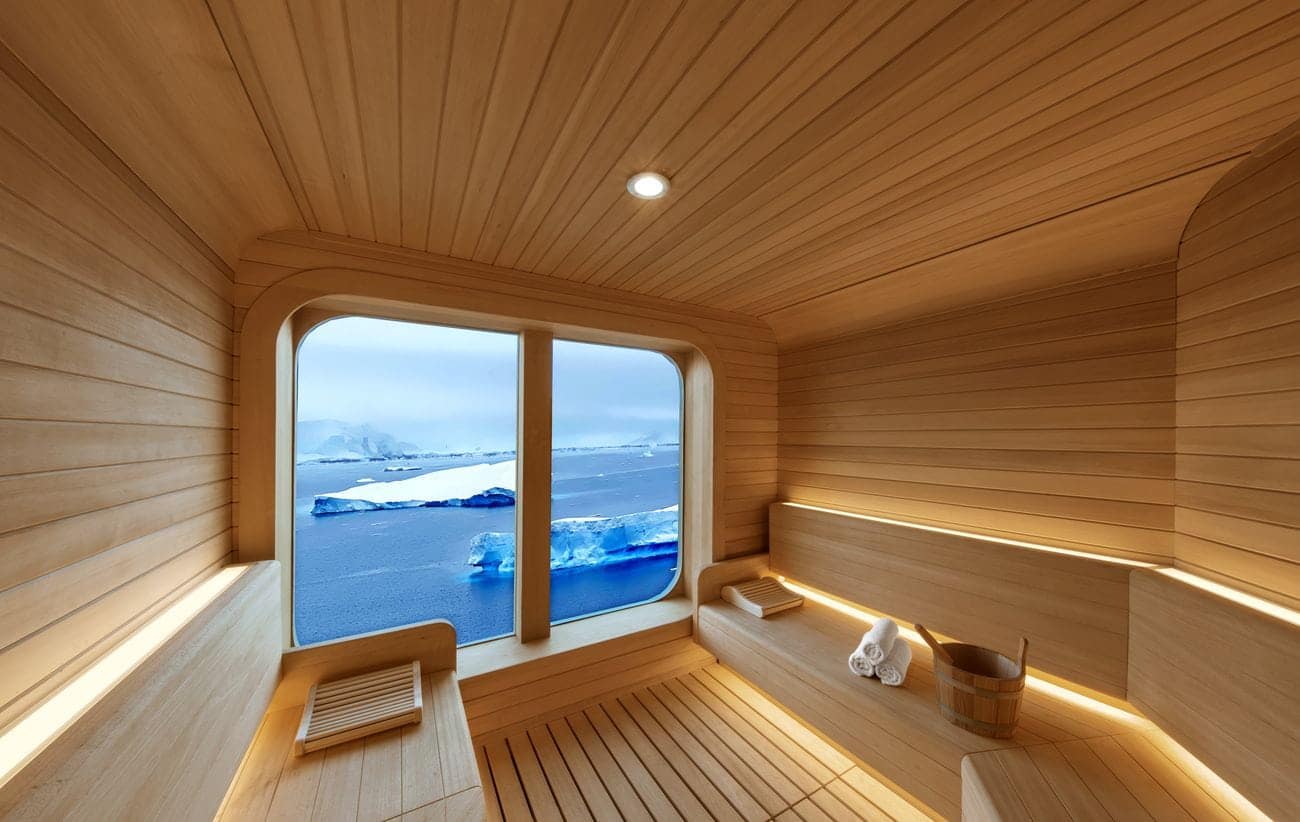 Wooden sauna aboard Seabourn Venture overlooking Antarctic icebergs through panoramic windows