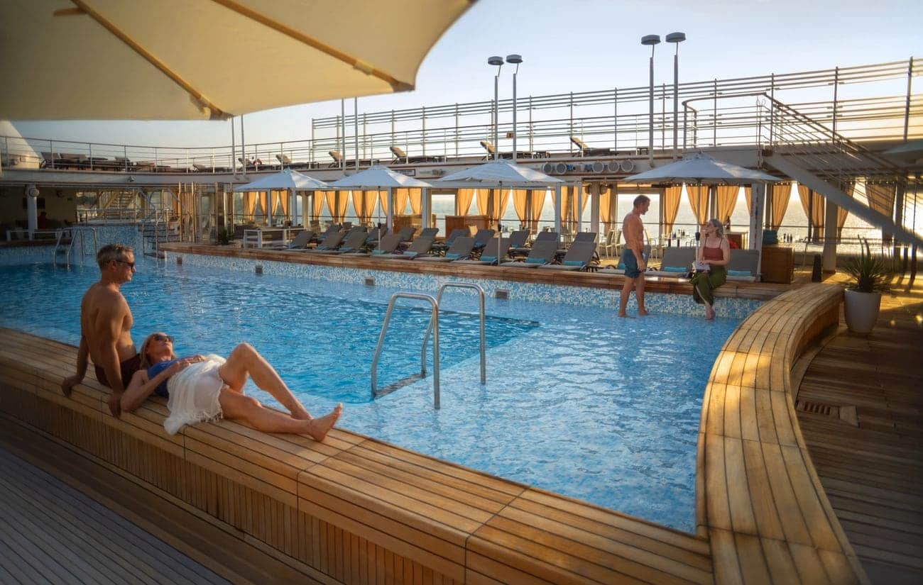 Guests relaxing beside the swimming pool on Silver Muse