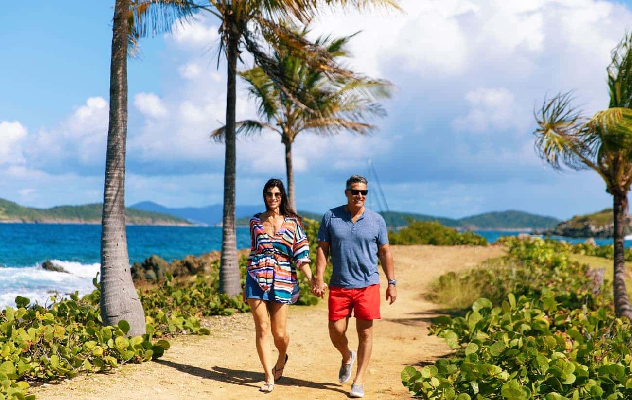 Couple walking along a tropical St Thomas pathway
