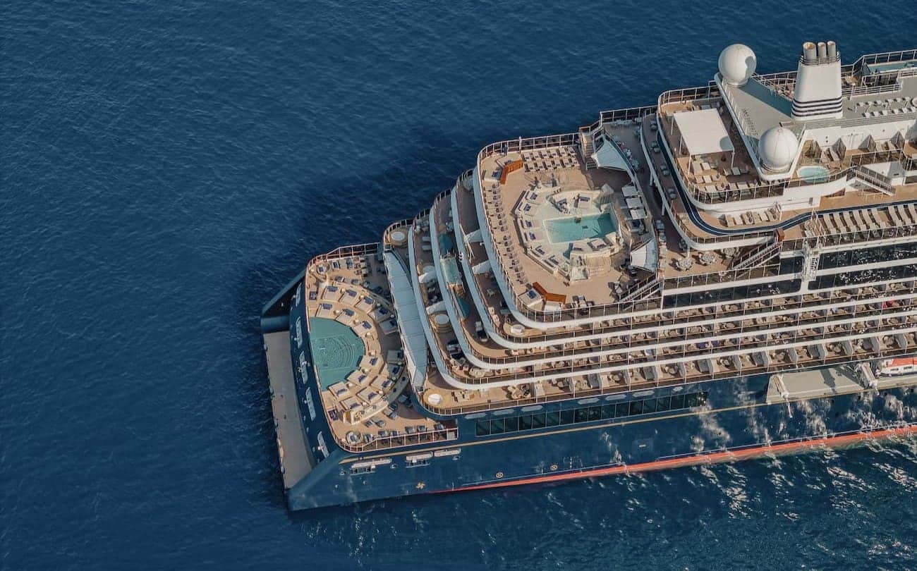 EXPLORA I viewed from above with tiered aft decks and pools at sea