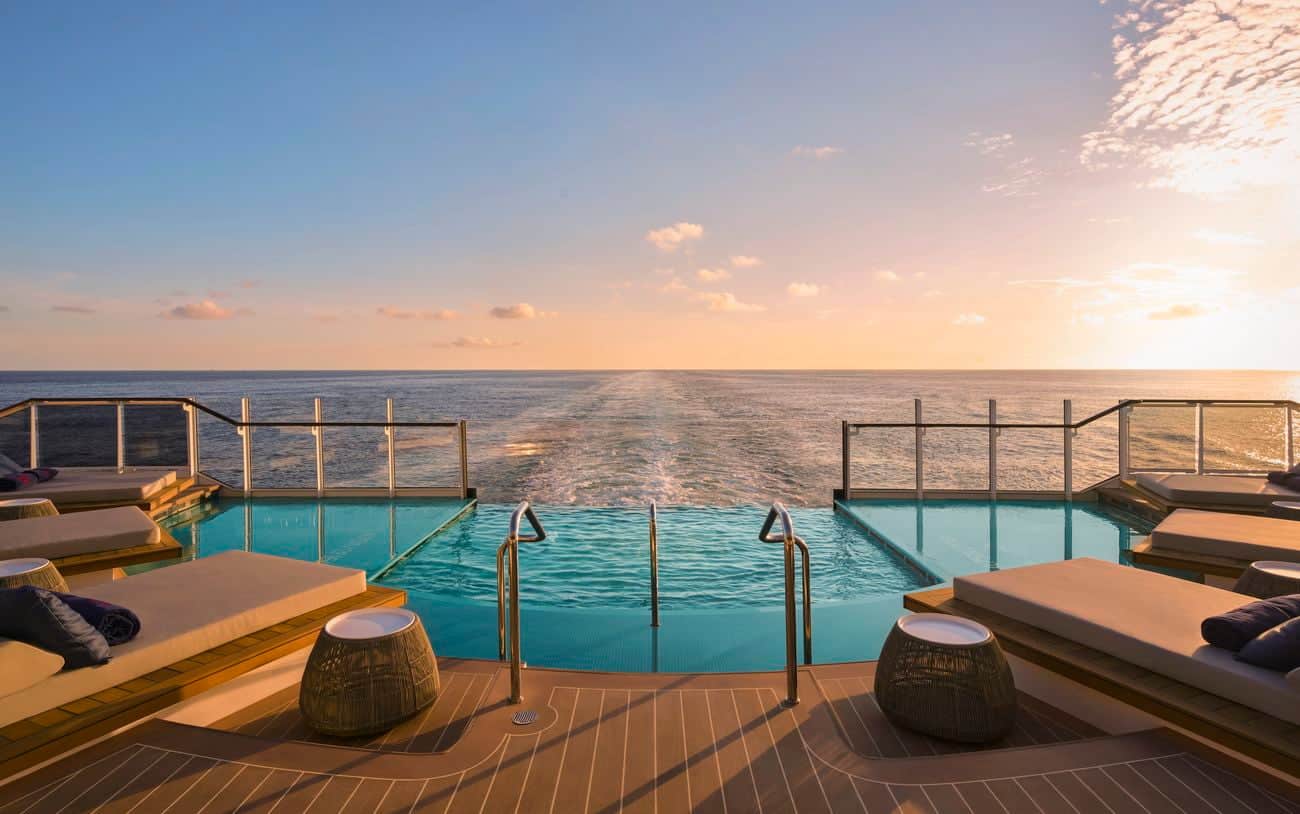 Astern Pool at sunset with ocean views and surrounding daybeds