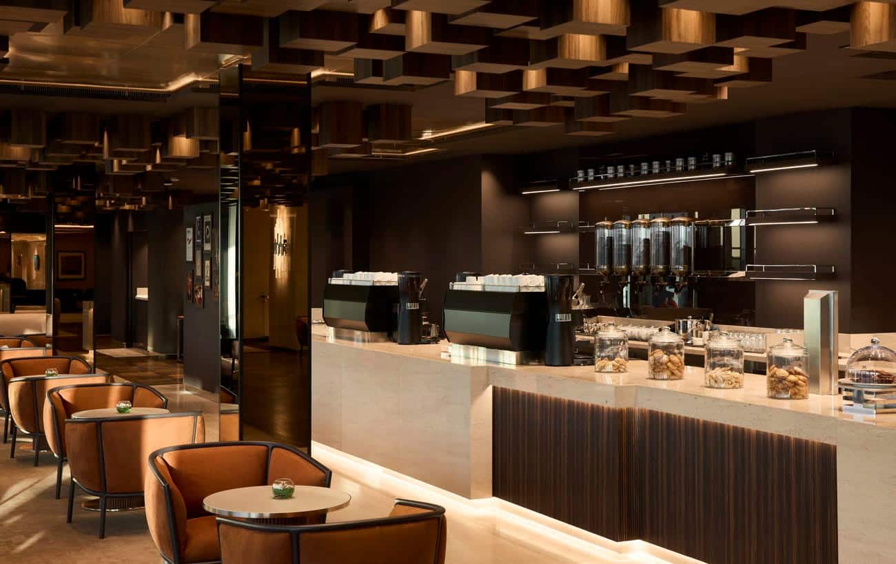 Crema Café interior with coffee counter and tan lounge chairs