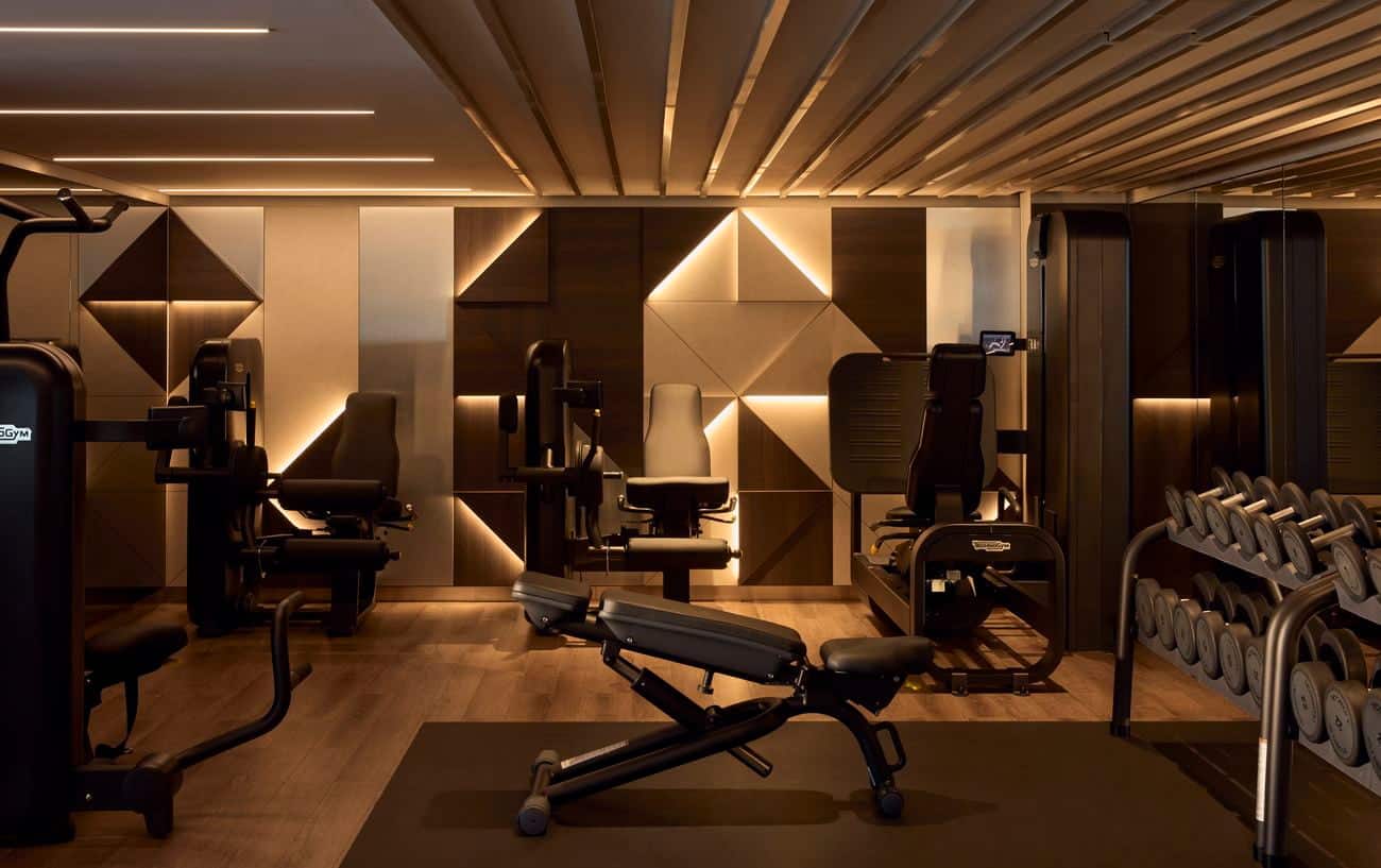 Fitness center with strength machines, weights and exercise bench