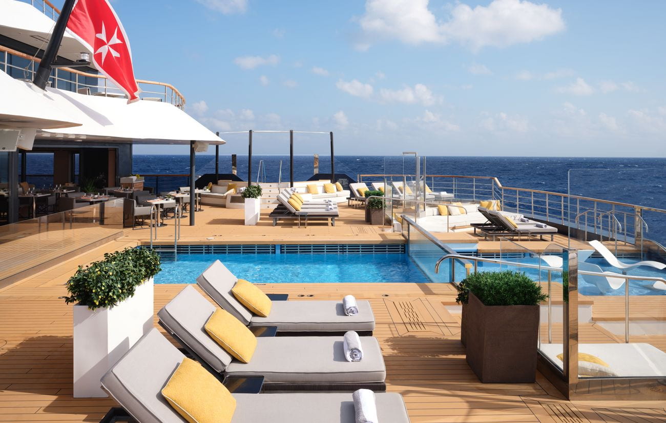 Outdoor yacht pool surrounded by sun loungers