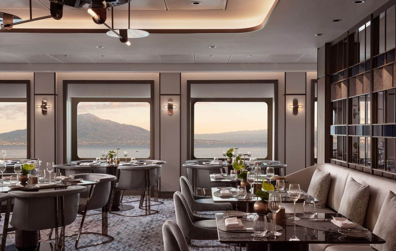 Azur restaurant aboard Luminara with elegant tables and panoramic coastal views