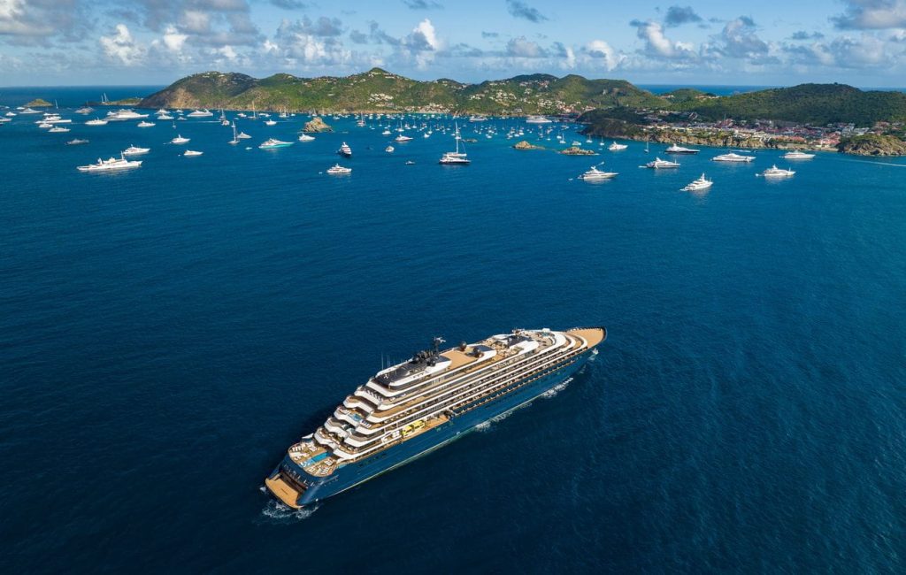 Aerial view of Evrima cruising off Saint Barthélemy among anchored yachts