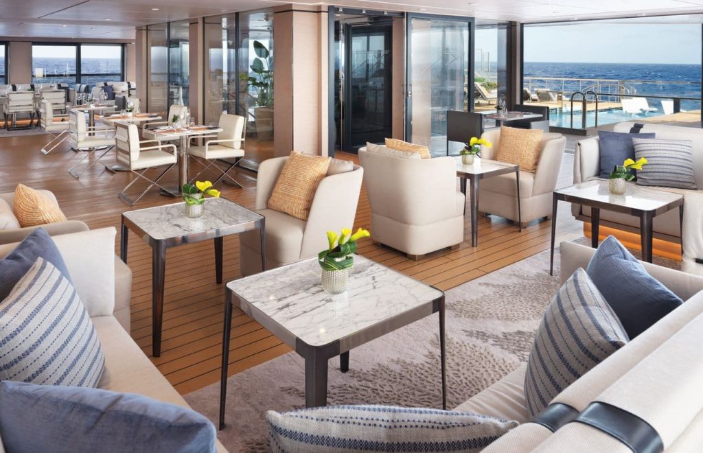 The Pool House aboard Evrima with lounge seating beside the pool