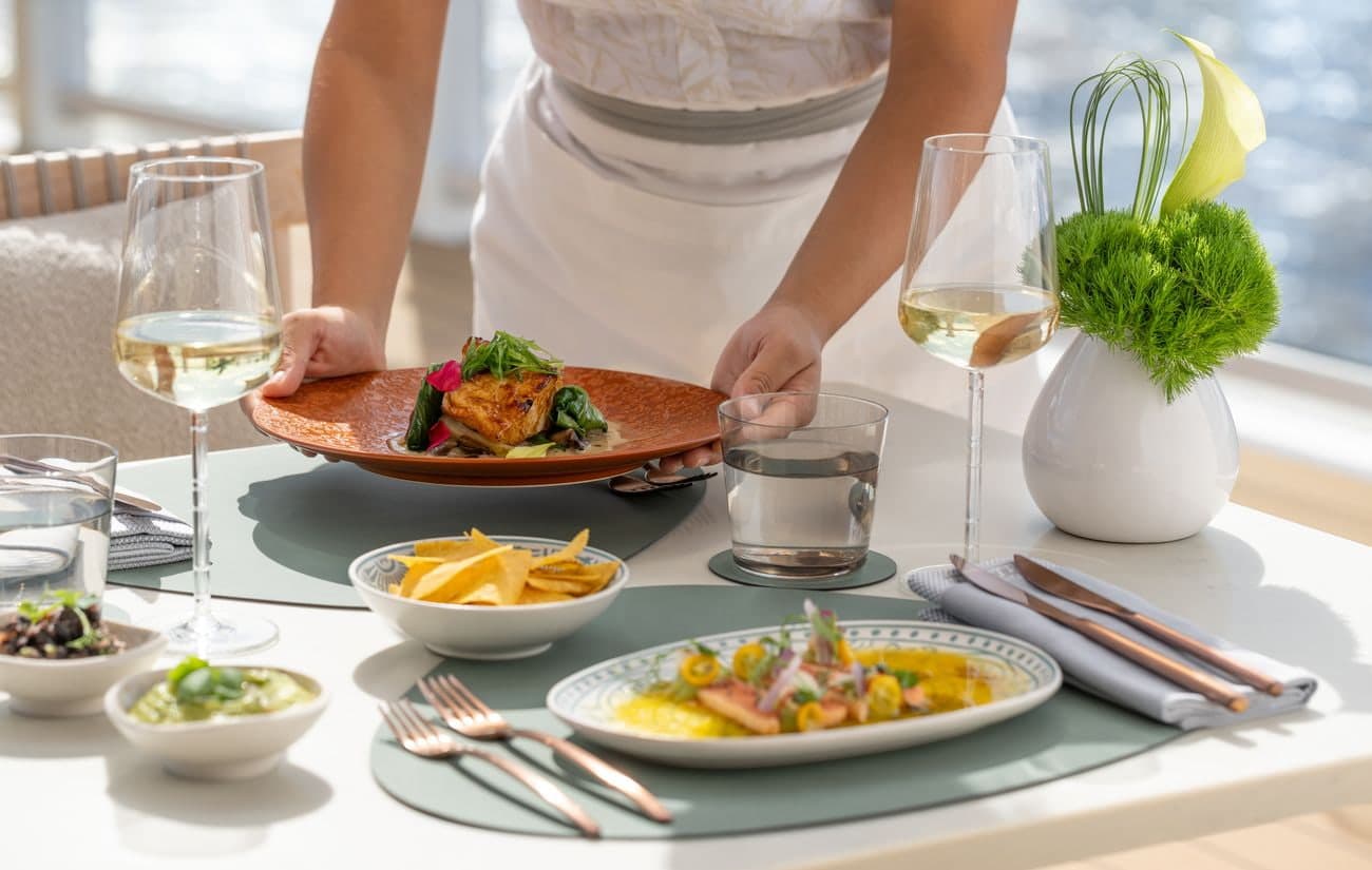 Beach House lunch service aboard Ilma with plated seafood and wine