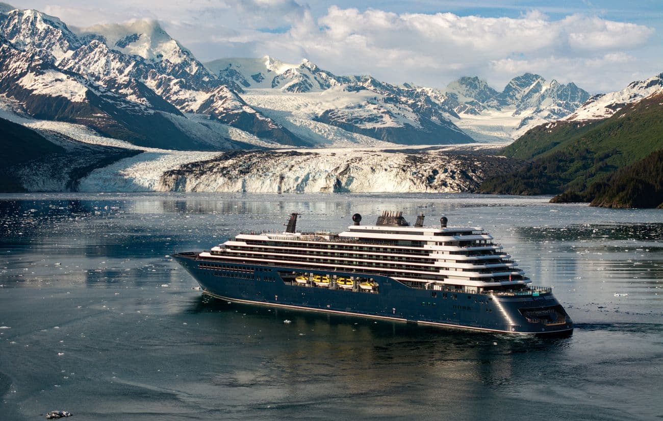Luminara sailing through icy waters beside an Alaska glacier